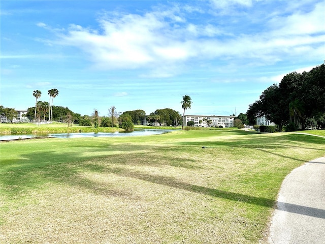 view of home's community featuring a lawn and a water view