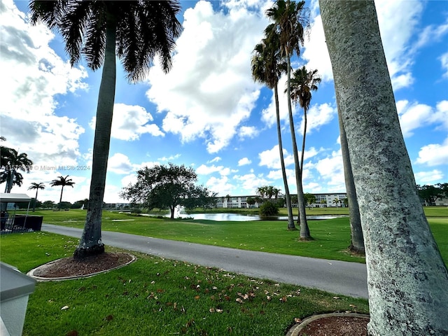 view of home's community featuring a water view and a yard