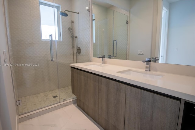 bathroom with a shower with shower door, tile flooring, and double sink vanity