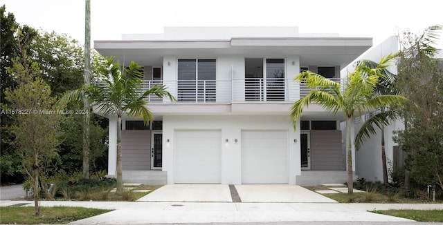 contemporary house featuring a garage and a balcony