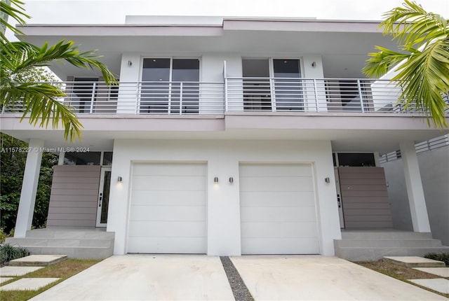 view of front of property with a garage and a balcony