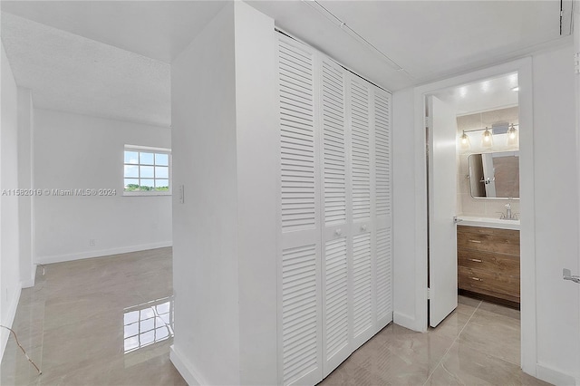 hallway featuring light tile floors