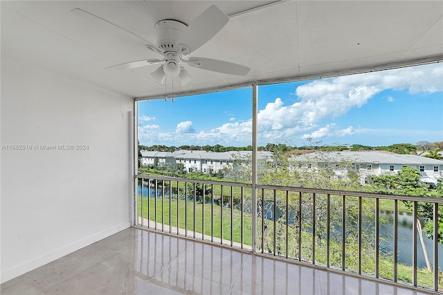 interior space with ceiling fan and a water view