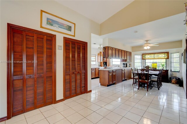 kitchen featuring light tile patterned floors, vaulted ceiling, and ceiling fan