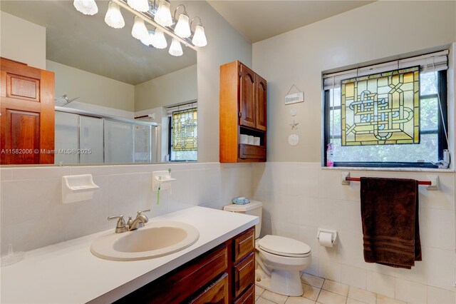 bathroom with tasteful backsplash, vanity, walk in shower, tile patterned flooring, and toilet