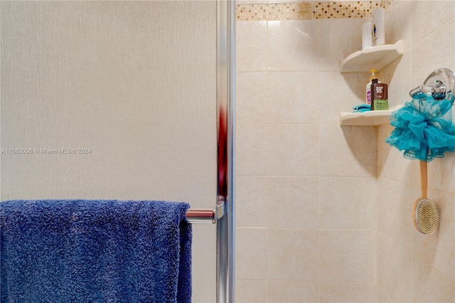 bathroom with a shower with shower door