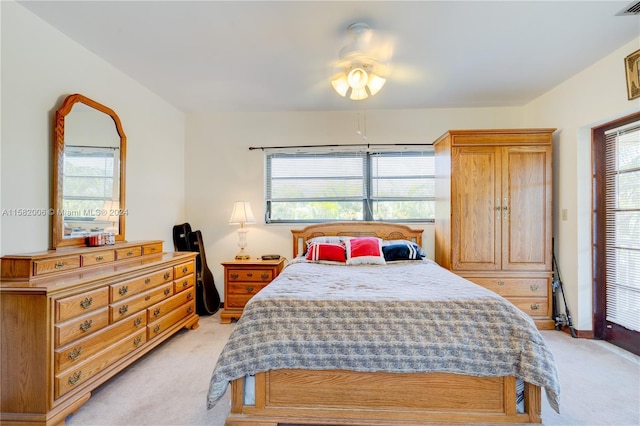 carpeted bedroom with multiple windows and ceiling fan