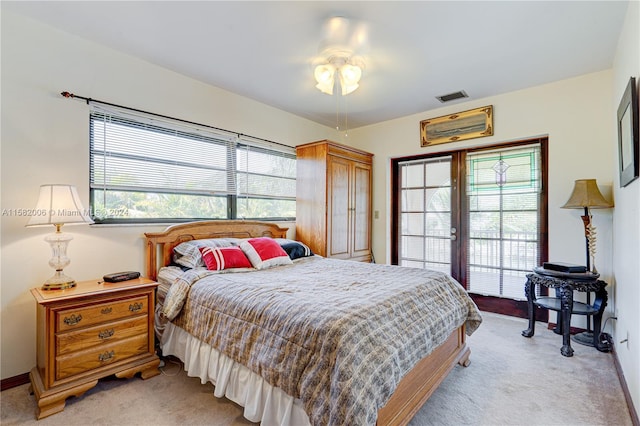 bedroom with light carpet, access to outside, and ceiling fan