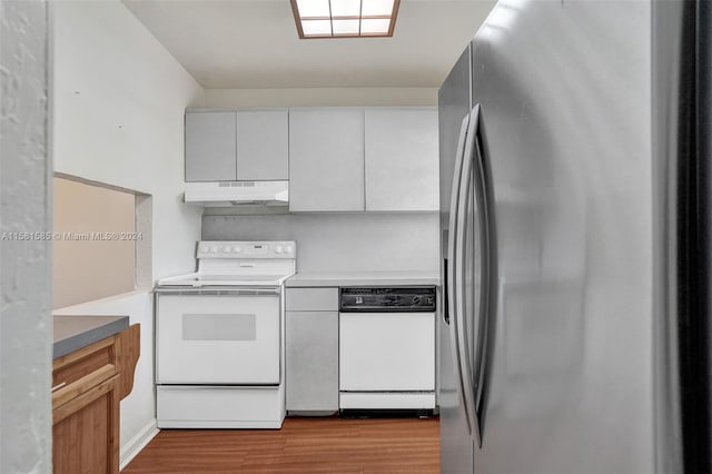 kitchen featuring wood-type flooring, white appliances, and white cabinetry