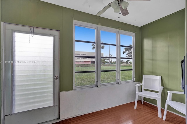 interior space with a healthy amount of sunlight, ceiling fan, and hardwood / wood-style floors