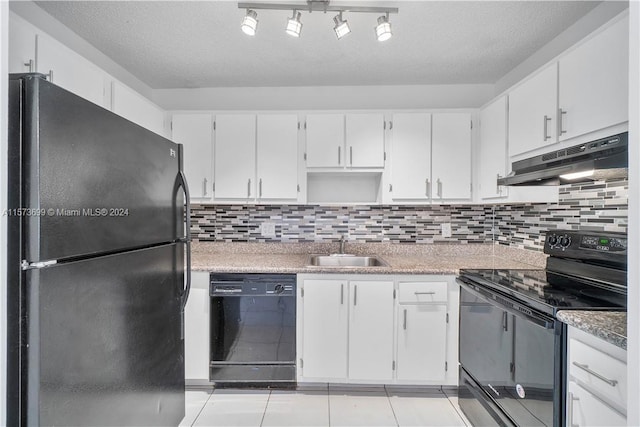 kitchen featuring black appliances, backsplash, rail lighting, light tile floors, and sink