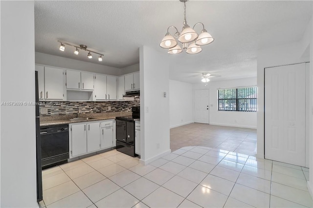 kitchen with light tile floors, tasteful backsplash, decorative light fixtures, black appliances, and track lighting