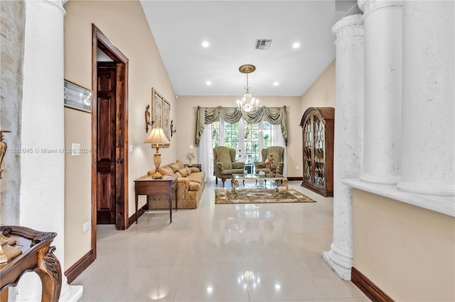 hall with ornate columns and light tile patterned flooring