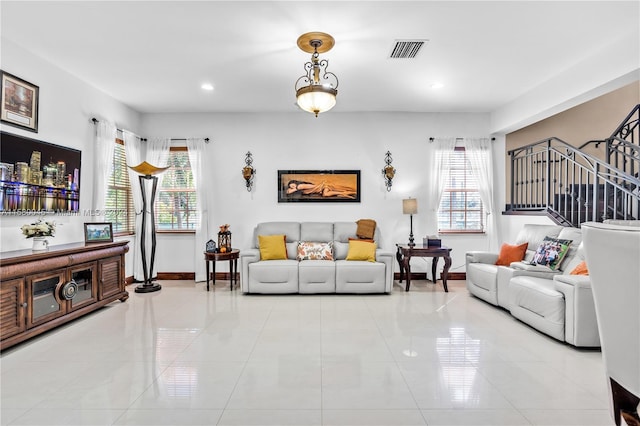 living room with a wealth of natural light and light tile patterned flooring