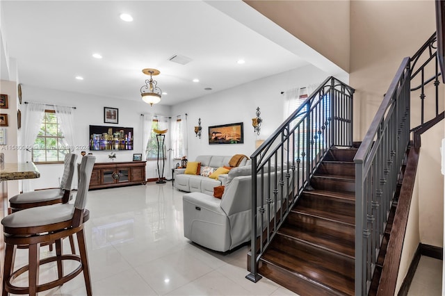 living room with tile patterned floors