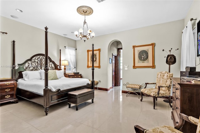 tiled bedroom featuring a notable chandelier