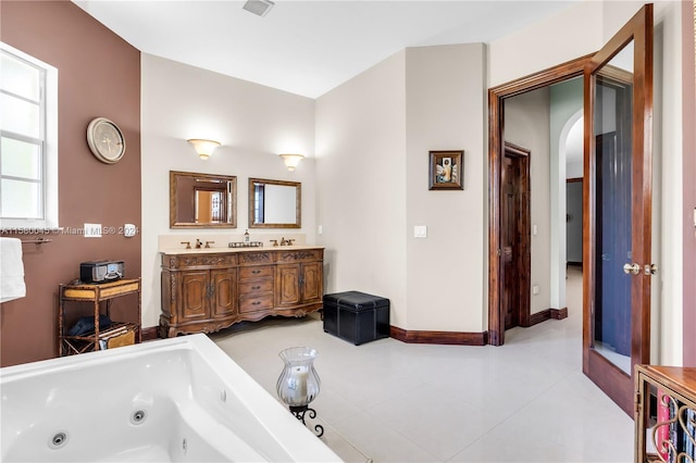 bathroom with tile patterned flooring and dual bowl vanity