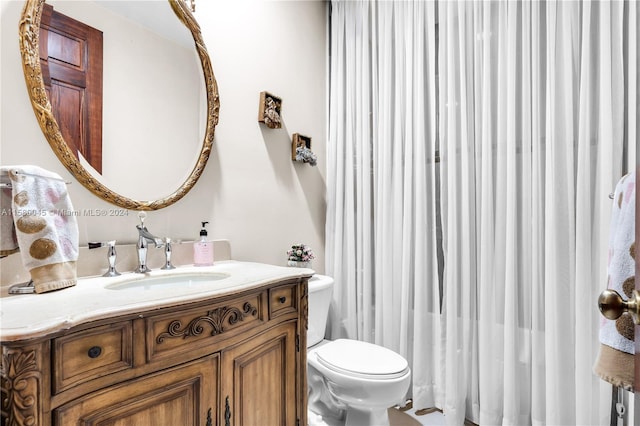 bathroom with toilet and vanity