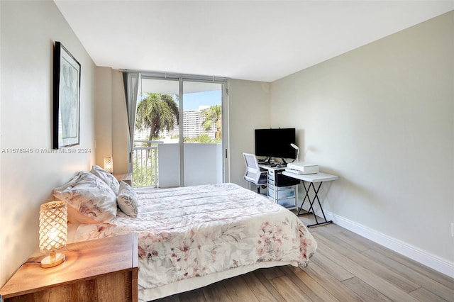 bedroom featuring hardwood / wood-style flooring and access to outside