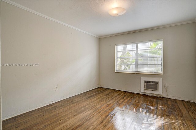 unfurnished room featuring dark hardwood / wood-style flooring, a wall mounted AC, and ornamental molding