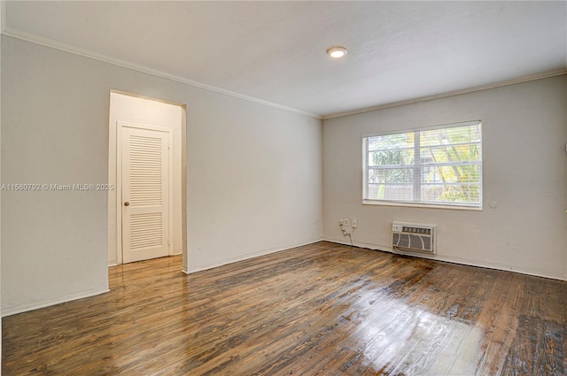 empty room featuring ornamental molding, dark hardwood / wood-style floors, and an AC wall unit