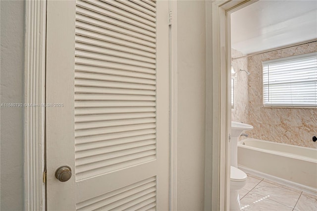 bathroom featuring toilet and a bath