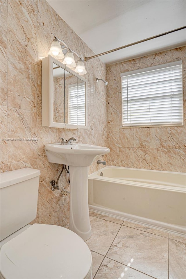 bathroom featuring toilet and tiled shower / bath combo