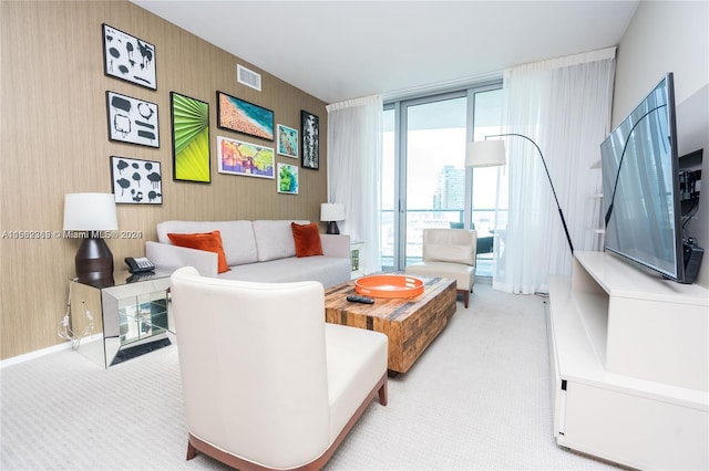 living room featuring floor to ceiling windows and carpet flooring