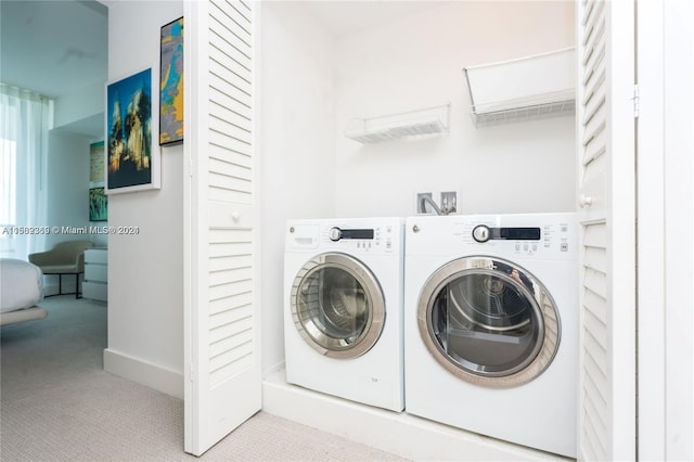 laundry area featuring carpet floors, hookup for a washing machine, and washer and dryer