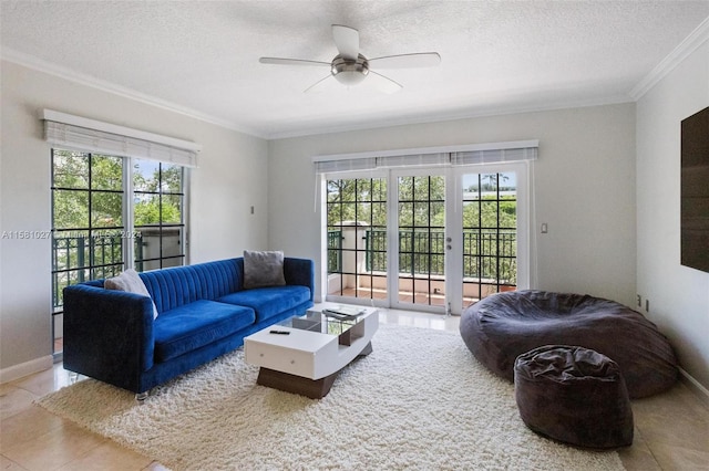 tiled living room with ceiling fan, crown molding, and a textured ceiling