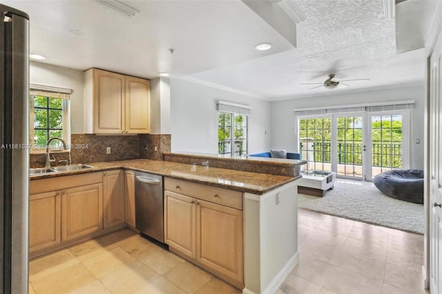 kitchen with kitchen peninsula, appliances with stainless steel finishes, sink, and light tile flooring