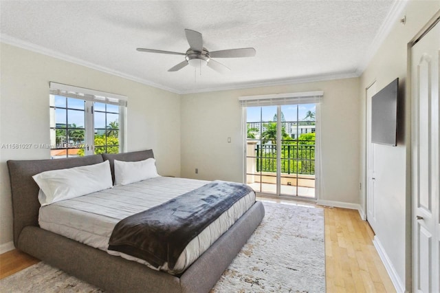 bedroom featuring ceiling fan, a textured ceiling, light hardwood / wood-style floors, crown molding, and access to outside