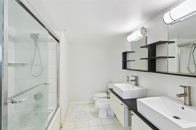 bathroom featuring a bidet, vanity with extensive cabinet space, toilet, and tile flooring