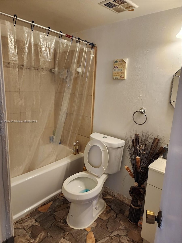 full bathroom with vanity, toilet, tile floors, and shower / bath combo with shower curtain