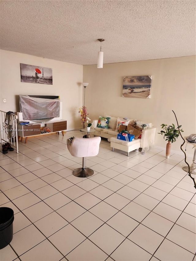 living room featuring a textured ceiling and light tile flooring