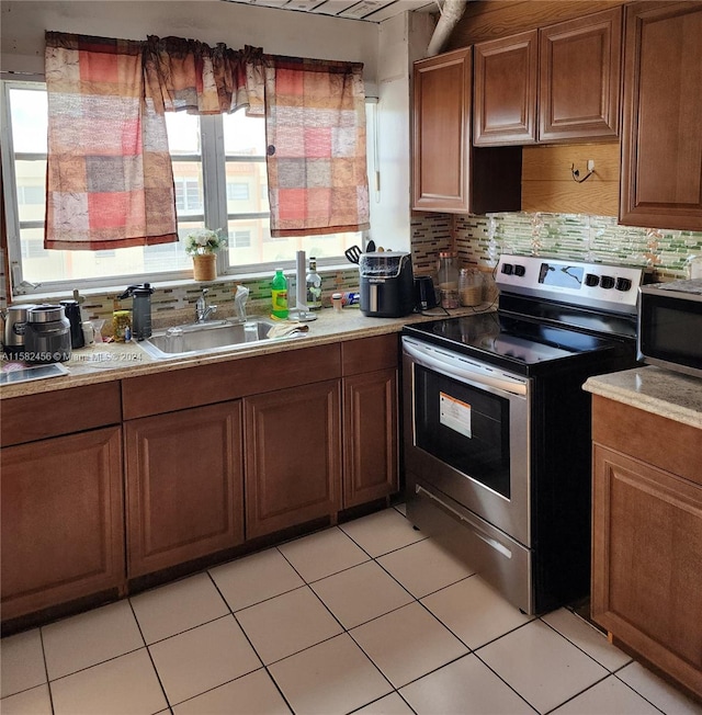 kitchen featuring plenty of natural light, tasteful backsplash, and stainless steel electric range