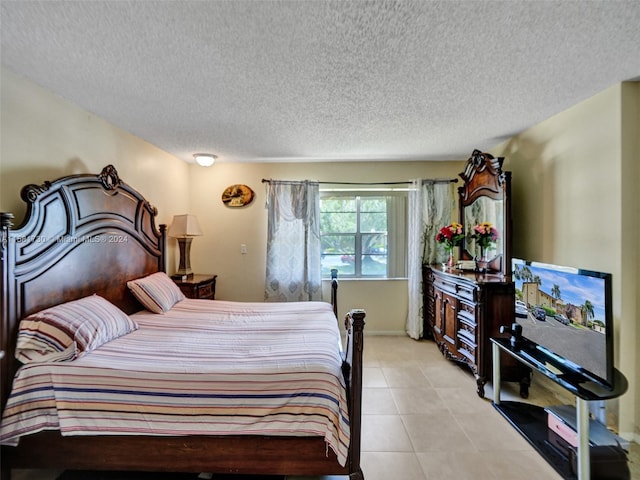 bedroom with tile flooring and a textured ceiling