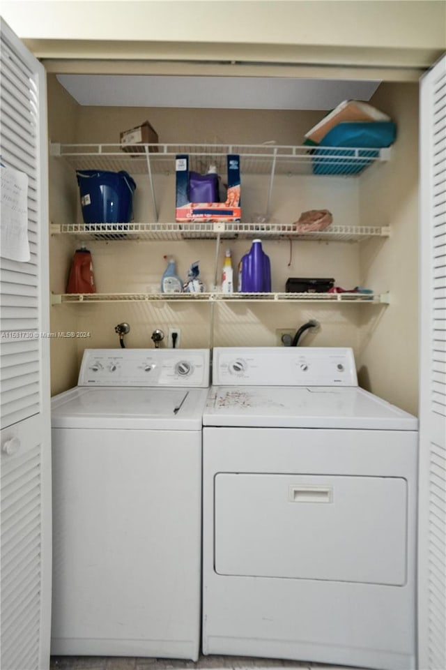 washroom with electric dryer hookup, washer hookup, and washing machine and clothes dryer