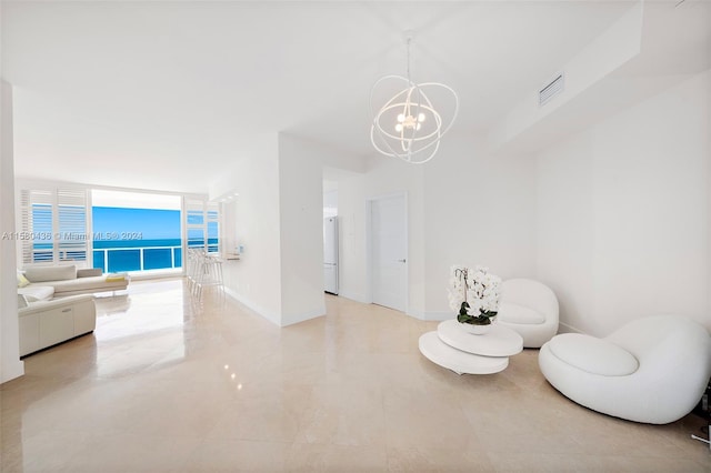 living area featuring expansive windows, light tile floors, and a chandelier