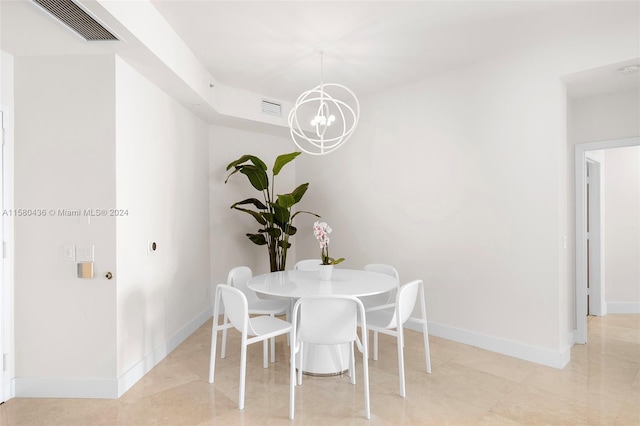 dining room featuring an inviting chandelier and light tile floors