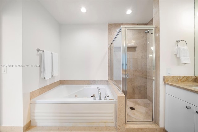 bathroom featuring tile flooring, vanity, and plus walk in shower