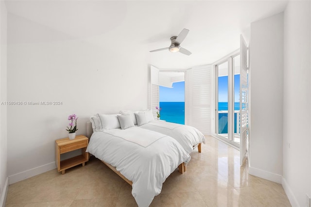 tiled bedroom with ceiling fan, access to exterior, and multiple windows