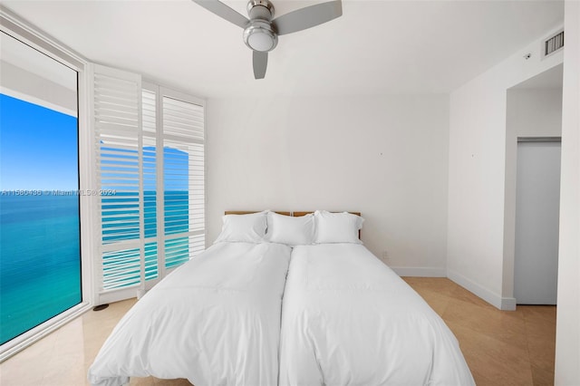 tiled bedroom featuring access to outside and ceiling fan