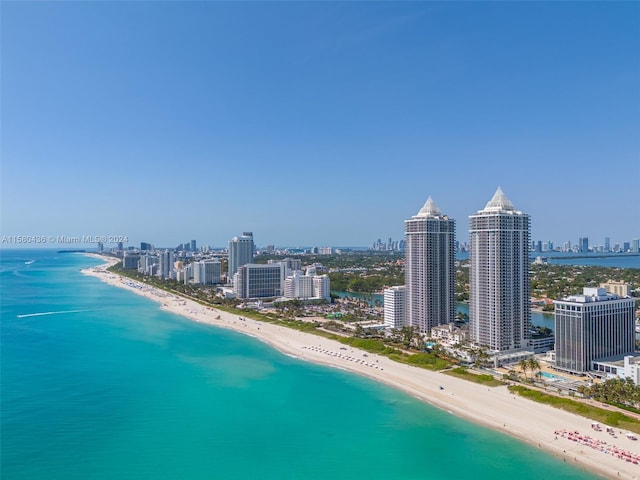 birds eye view of property featuring a view of the beach and a water view