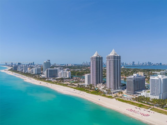 bird's eye view with a water view and a beach view