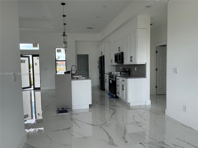 kitchen featuring electric range oven, hanging light fixtures, white cabinets, black fridge, and light tile floors