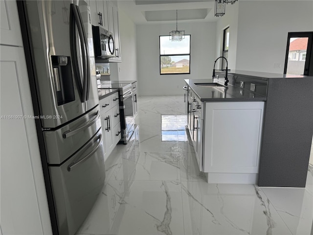 kitchen featuring stainless steel appliances, white cabinetry, sink, and light tile flooring