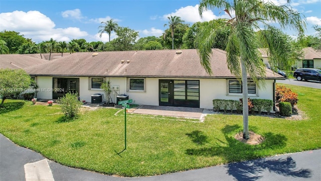 ranch-style home featuring a front yard and central AC unit