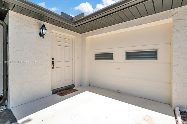 view of exterior entry with a garage