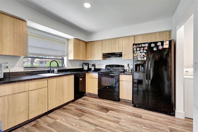 kitchen featuring light brown cabinets, sink, dark stone counters, black appliances, and light hardwood / wood-style flooring